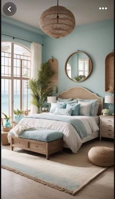 a bedroom with blue walls and white bedding