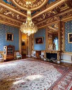 an ornately decorated room with blue walls and gold trimmings is pictured in this image