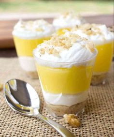 three desserts are sitting on a table with spoons