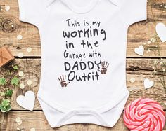 a baby bodysuit that says, this is my working in the garage with daddy outfit