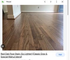 an empty living room with hard wood flooring