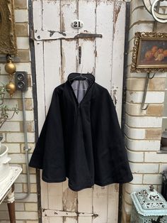 Antique Dutch handmade black wool fishermans cape with blue lining and stand up collar one size. Dutch, circa 1890. 100% Wool. Rigid stand up collar, black wool exterior with blue wool lining, hook & eye fastening. Size: Length: 34 inches (from top of collar to hem). Weight: allow 5 kg volumetric weight once packed. Good condition for its age. Great costume for play or theatre production (if not to be worn). Black Cape For Larp, Vintage Black Cape For Winter, Vintage Black Winter Cape, Black Wool Cape Poncho, Cottagecore Apothecary, Theatre Production, Dark Cottagecore, Stand Up Collar, Charity Shop