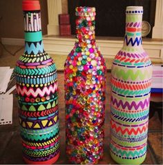 three colorful vases sitting next to each other