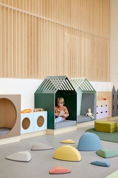 a child's playroom with various colored furniture and toys on the floor in front of it