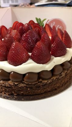 a chocolate cake with strawberries on top