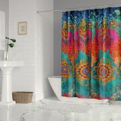 a colorful shower curtain in a white bathroom