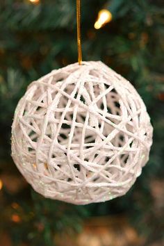 a white ornament hanging from a christmas tree