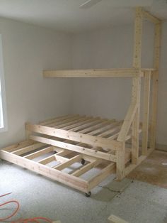 a bed frame is being built in an empty room