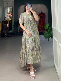 This pista green georgette frock dress with floral prints is a versatile and elegant addition to any wardrobe. Its timeless design, paired with the contemporary appeal of floral prints, makes it suitable for a wide range of occasions. 
This exquisite dress is crafted from premium georgette fabric, offering a soft and flowing silhouette that enhances every body type. Available in sizes XS to L, this fully stitched frock dress ensures a perfect fit, combining comfort with style.
The pista gre Frock Type Kurti Designs, Green Chiffon Midi Dress With Floral Print, Casual Green Chiffon Midi Dress, Green Chiffon Midi Dress For Spring, Green Chiffon Dress For Garden Party, Green Chiffon Maxi Dress With Short Sleeves, Green Chiffon Spring Dress, Green Chiffon Midi Dress With Short Sleeves, Green Chiffon Short Sleeve Dress