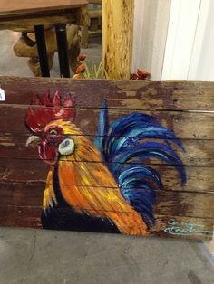 a painted wooden sign with a rooster on it