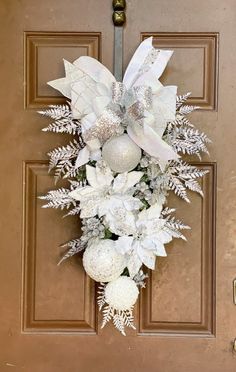 a door decorated with white flowers and ornaments