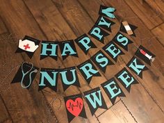 a banner that says happy nurses week hanging on a wooden floor with other decorations around it