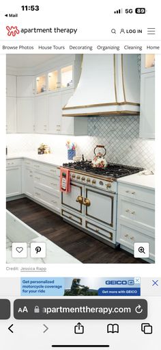 an image of a kitchen with white cabinets and gold trim on the oven, counter tops