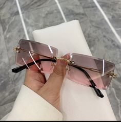 Be seen in a bold, new look with these Frameless Rectangle Shades. Stylishly rimless with UV400 lenses crafted from Polycarbonate, they will protect your eyes from the sun's harmful rays. Stylish and sophisticated, their 60mm x 52mm frame of lightweight alloy ensures a perfect fit while making a statement. So why not make your mark with these extraordinary sunglasses? Product Details Style: Rimless Lenses Optical Attribute: UV400 Lenses Material: Polycarbonate Lens Width: 60mm Lens Height: 52mm Outdoor Sunglasses, Gold Gradient, Beach Sunglasses, Rimless Sunglasses, Color Lenses, Rectangle Sunglasses, Moda Vintage, Gold Sunglasses, Eyeglass Case