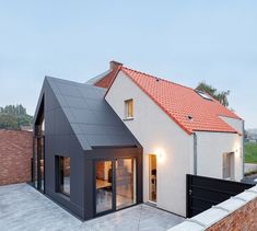 a house with a red roof and white walls