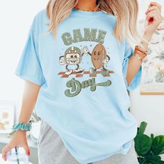 a woman wearing a t - shirt that says game day