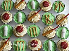 cupcakes with green frosting and white icing decorated with sports related decorations