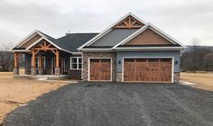 a large house with two garages in the front and one attached to it's side