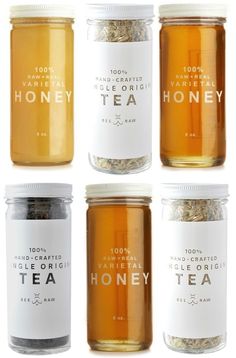 four jars filled with different types of tea