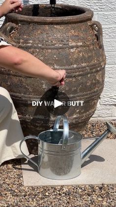 a woman is pouring water into a large pot on the side of a building with words that read true or fake diy