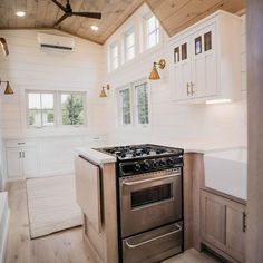 a stove top oven sitting inside of a kitchen