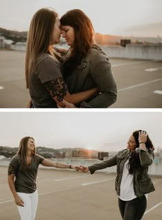 two women are holding hands and smiling while standing in an empty parking lot with the sun setting behind them