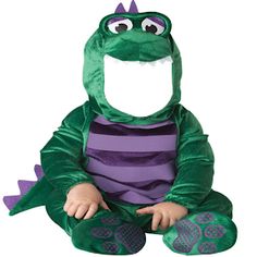 a small child in a green and purple costume sitting on the ground with his legs crossed