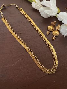 South Indian Bridal Traditional One Gram Jewelry Necklace Set with Earrings. Temple choker set. Gorgeous 24 K gold plated. This Necklace set comes in a beautiful gift box, making it an ideal gift for birthdays, weddings or anniversaries. Occasion: Perfect choice for any Indian occasion. Care: It is advisable that you keep products away from direct heat, humidity, and moisture. It is best to preserve your jewelry in the bag/box provided with the package. 100% Satisfaction Guarantee, Highest quali Coin Mala Gold, Coin Chain Gold Indian, Long Necklace Gold Indian Jewelry Sets, Mala Set In Gold, Golden Jewelry Indian, Coin Necklace Gold Indian, Long Gold Necklace Indian, Long Necklace Gold Indian, Indian Gold Chain