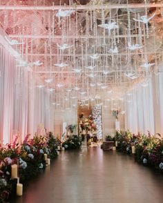 an indoor wedding venue with chandeliers and flowers