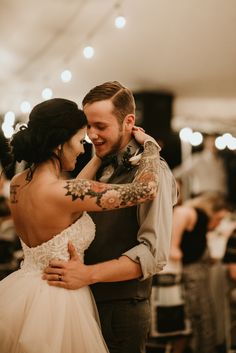 a bride and groom dance together at their wedding reception