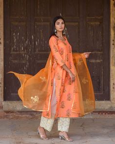 Orange Silk Printed Kurta Suit Set with Organza Dupatta The set consists of silk printed kurta round neck, 3/4th sleeves teamed with contrast gold chikan palazzo pants and an organza dupatta with handcraft gota motif Kurta Length-45 inches (can be customised) Pant Length- 36 inches (can be customised) Dupatta - 2.5 meters Work-Print Work Color-Orange Top Fabric -Silk Bottom Fabric - Chikan Dupatta Fabric-Organza Sleeves - 3/4th Sleeves Neck-Round Washing Care-Dry Clean Gulabo Jaipur, Suits Usa, Reception Look, Kurta Set For Women, Organza Sleeves, Indian Bridal Dress, Silk Bottoms, Silk Kurta, Organza Dupatta