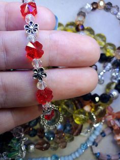 Swarovski red crystal flowers on a dainty spring bracelet. Red Crystal Bracelet Gift, Red Crystal Bracelet For Gift, Red Crystal Beaded Bracelets, Adjustable Red Crystal Bracelet, Adjustable Red Crystal Bracelets, Silver Flower Crystal Bracelet Gift, Silver Flower Crystal Bracelet As Gift, Silver Flower Crystal Bracelet For Gift, Red Bracelets With Silver Beads For Jewelry Making