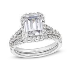 an emerald cut diamond engagement ring set with two matching bands on the band and side stones