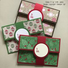 four christmas cards, each with a different type of holiday card on top of it