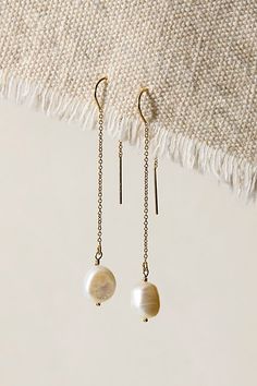 Elevate your earring game with these stunning threaders, featuring a shiny metal finish and dainty chain detailing with beautiful keshi pearls. **Features:** Gold: 14k gold filled, silver: sterling silver, 9mm keshi pearls, 2.5" length **Why We ❤ It:** These delicate earrings are the perfect unique addition to any jewelry box. **Please Note:** Due to natural variation, each pearl will differ slightly. Keep earrings dry and out of water for best results. Pearls are a soft stone so wear these gently. | Set & Stones Sabina Threaders at Free People in Gold Delicate Gold Pearl Threader Earrings, Delicate Gold Threader Earrings With Pearl Charm, Gold Pearl Dangle Threader Earrings, Gold Dangle Pearl Threader Earrings, Gold Pearl Threader Earrings Gift, Adjustable Gold Threader Earrings With Pearl Drop, Gold Pearl Drop Threader Earrings, Gold Threader Earrings With Pearl Drop, Elegant 14k Gold Filled Pearl Drop Threader Earrings