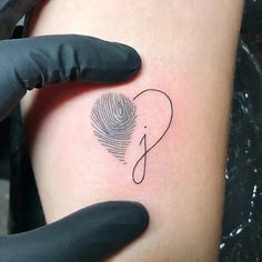 a person with a fingerprint on their left arm and the word love is written in black ink