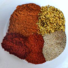 various spices in a white bowl on a table