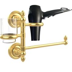 a hair dryer and glass on a wall mounted holder with two arms that hold the hairdryer