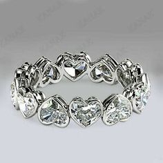 a white gold ring with heart shaped diamonds