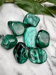 This listing is for ONE tumble. Malachite is a treasured material among mineral and crystal collectors. The meszmerizing, swirling patterns are unique on each rock. Varying shades of green from pale mint to rich jungle green hues, combine to create a lovely visual aesthetic. One tumble will be selected with intention. Each tumble measures approximately 1.50 in. x .80 in. and weighs approximately 2oz. These measurements are approximate. Each stone will measure slightly different. Malachite Aesthetic, Malachite Green Aesthetic, Gemstones Aesthetic, Malachite Decor, Luxury Malachite Jewelry With Natural Stones, Malachite Crystal Aesthetic, Crystals Aesthetic, Spiritual Aesthetic, Malachite And Azurite