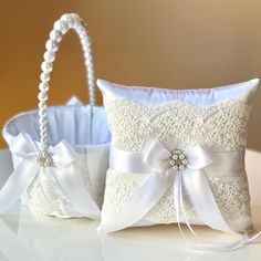 two wedding ring bearer pillows and a basket