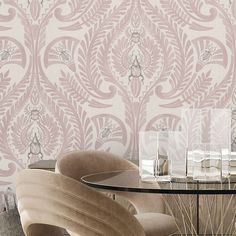 an elegant dining room with pink wallpaper and glass table set for four, surrounded by chairs