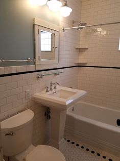 a bathroom with a toilet, sink and bathtub