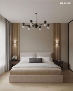 a large bed sitting under a chandelier in a bedroom next to a window