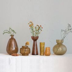 several vases are lined up on a table