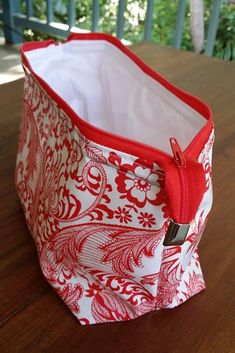 a red and white bag sitting on top of a wooden table