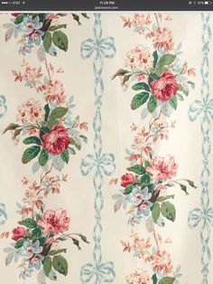 a floral wallpaper pattern with roses and leaves on white background, closeup view