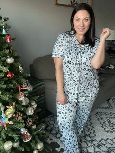 The cutest and comfiest pajamas in our favorite buttery-soft fabric are back in a button front option! Functional Button Front Chest Pocket on top Black piping detail Higher waisted than her original pajamas but has same elastic waist and satin ribbon tie Pockets on the pants Oversized fit, size down if you are between sizes or prefer less loose. I do recommend sizing down for most. Fabric content: 92% Polyester 8% spandex Amanda is wearing her normal size XL in the trees print and sized down to Trees Print, Grey Leopard, Pajamas Comfy, Ribbon Tie, Tree Print, Satin Ribbon, Oversized Fits, Piping, A Button