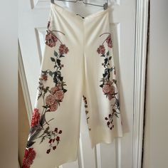 Zara Woman Culotte Floral Print Trouser In Like New Condition. This Item Was Never Worn. Side Zipper Shown In Pictures. The Pink Toned Floral Print Is Perfect Over An Ivory Fabric. Elegant Floral Print Bottoms For Brunch, Elegant White Printed Bottoms, Chic White Floral Print Wide Leg Pants, Elegant High Waist Floral Print Bottoms, Floral Print Wide Leg Bottoms For Brunch, Elegant Wide Leg Printed Pants, Elegant Printed Wide-leg Pants, Elegant Printed Spring Bottoms, White High-waisted Pants With Floral Print