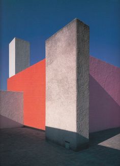 an abstract painting of two blocks in front of a blue sky and red building with white walls